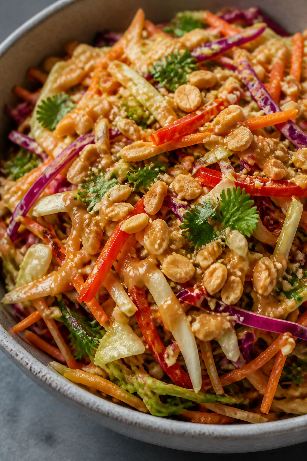 Thai peanut crunch salad with cabbage carrots cilantro and peanuts in a bowl