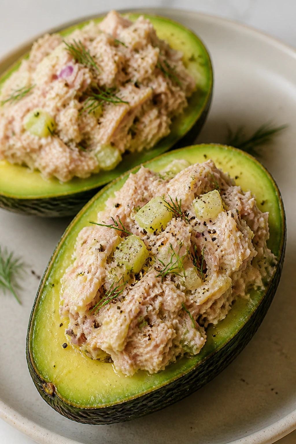 Close-up of tuna salad stuffed avocados on a plate