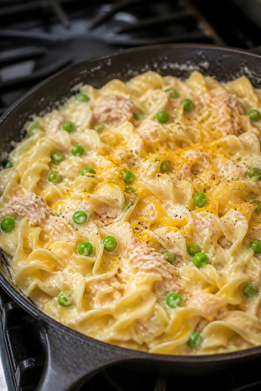 Creamy tuna noodle skillet with peas and cheddar