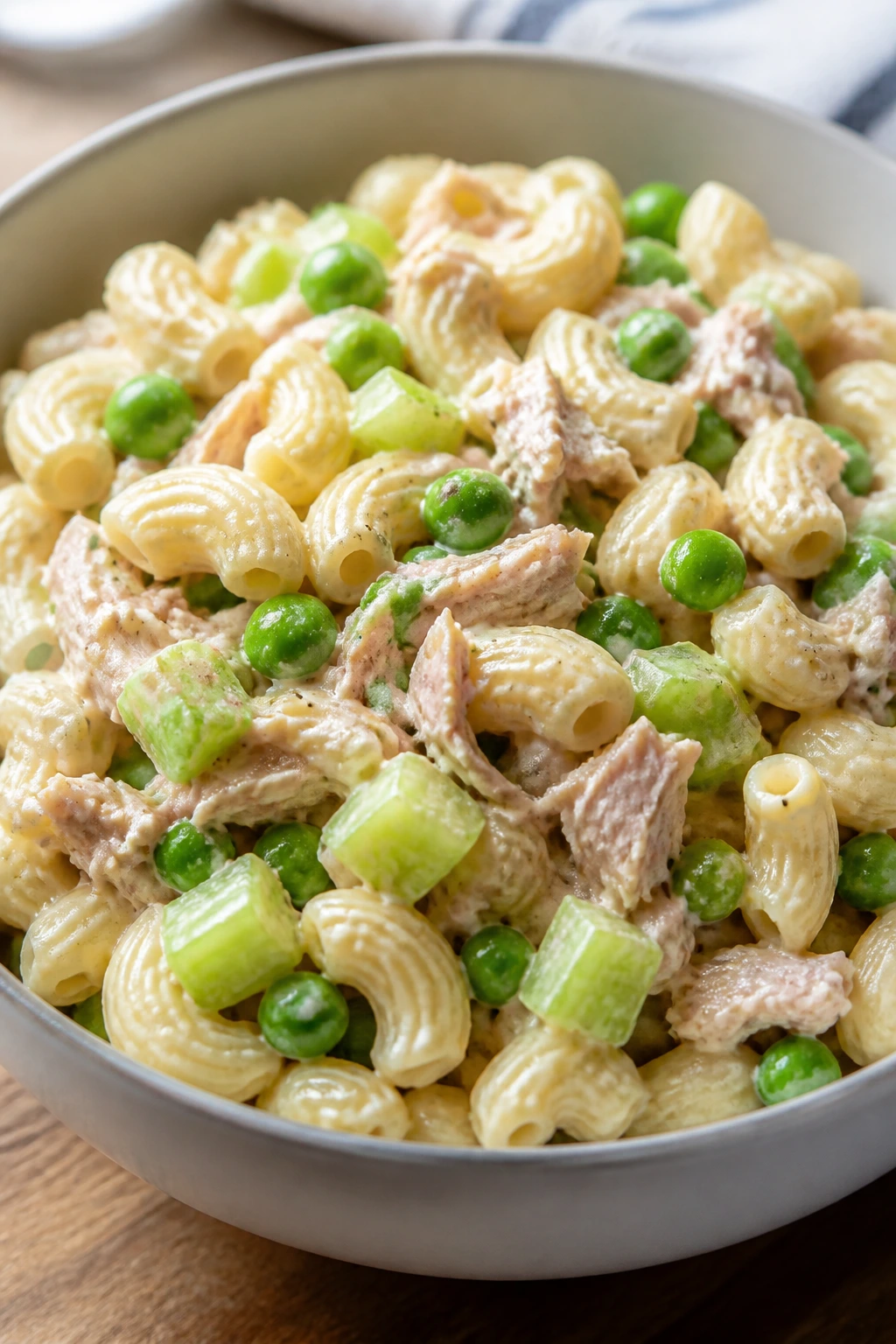 Creamy tuna pasta salad with peas in a bowl