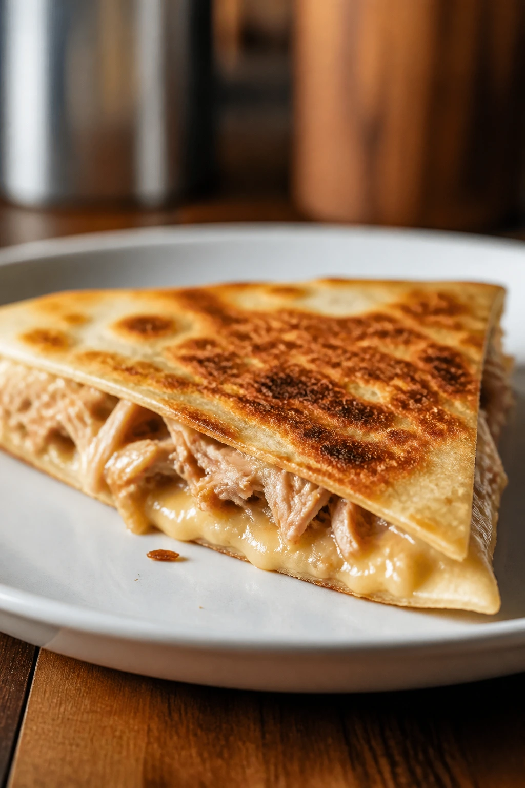 Quesadilla half with melted cheese on a plate
