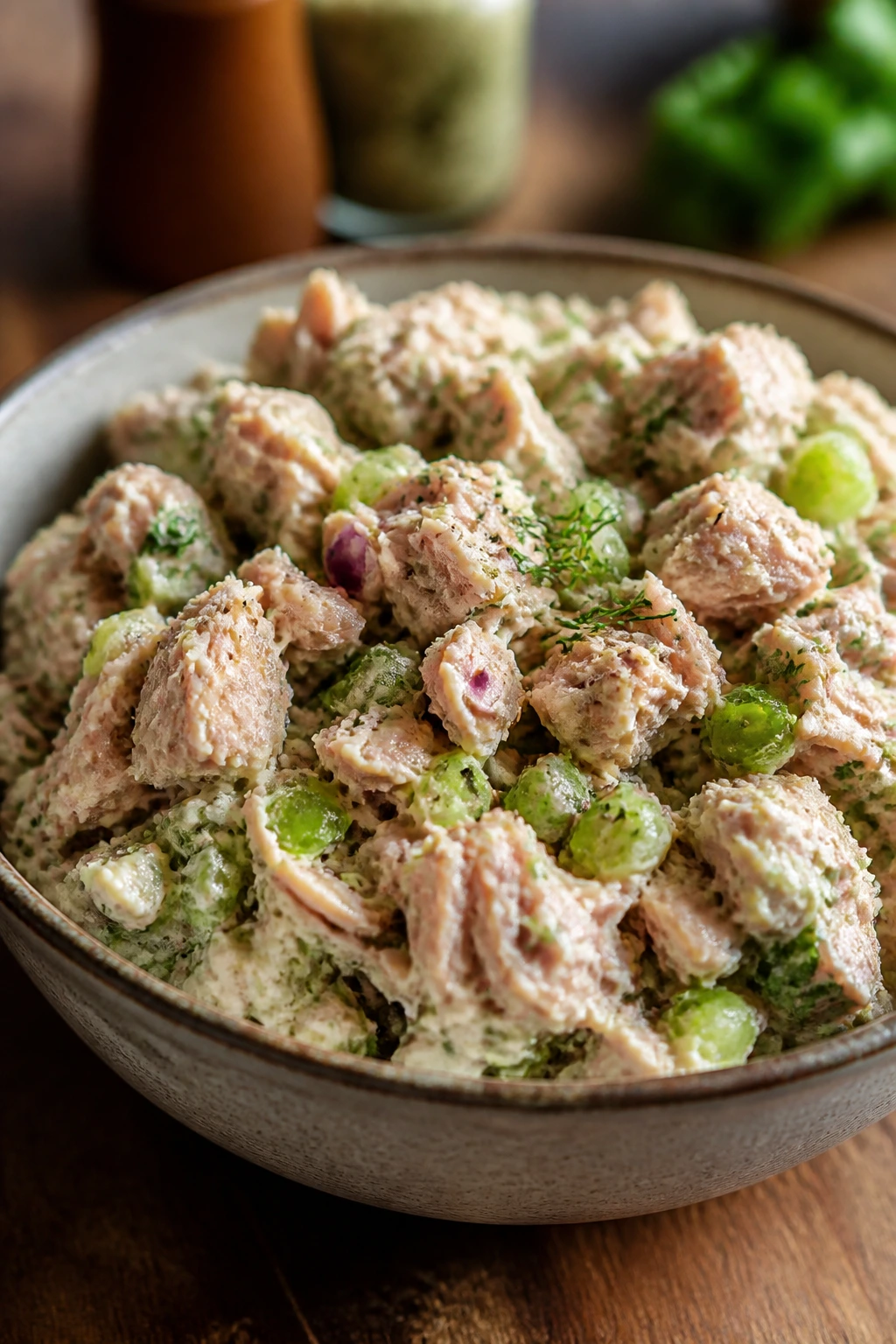 Close-up of a tuna salad bowl with celery crunch and creamy dressing on rustic kitchen counter