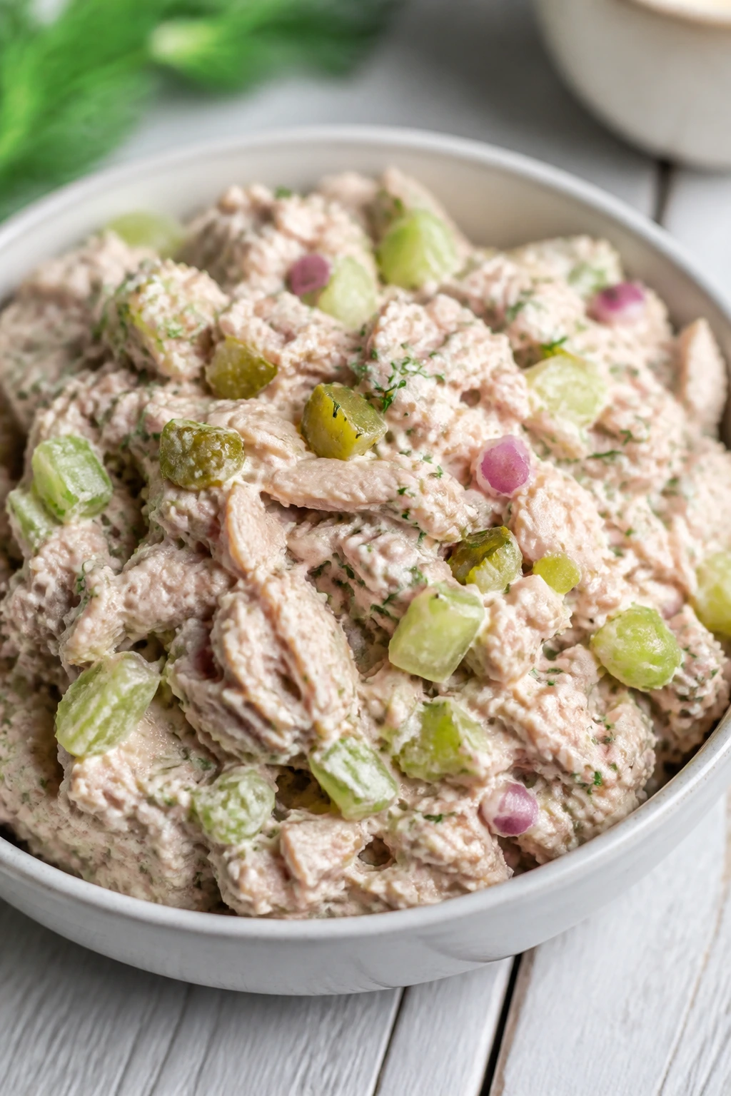 Plate of light tuna salad with homemade dressing in a bright kitchen