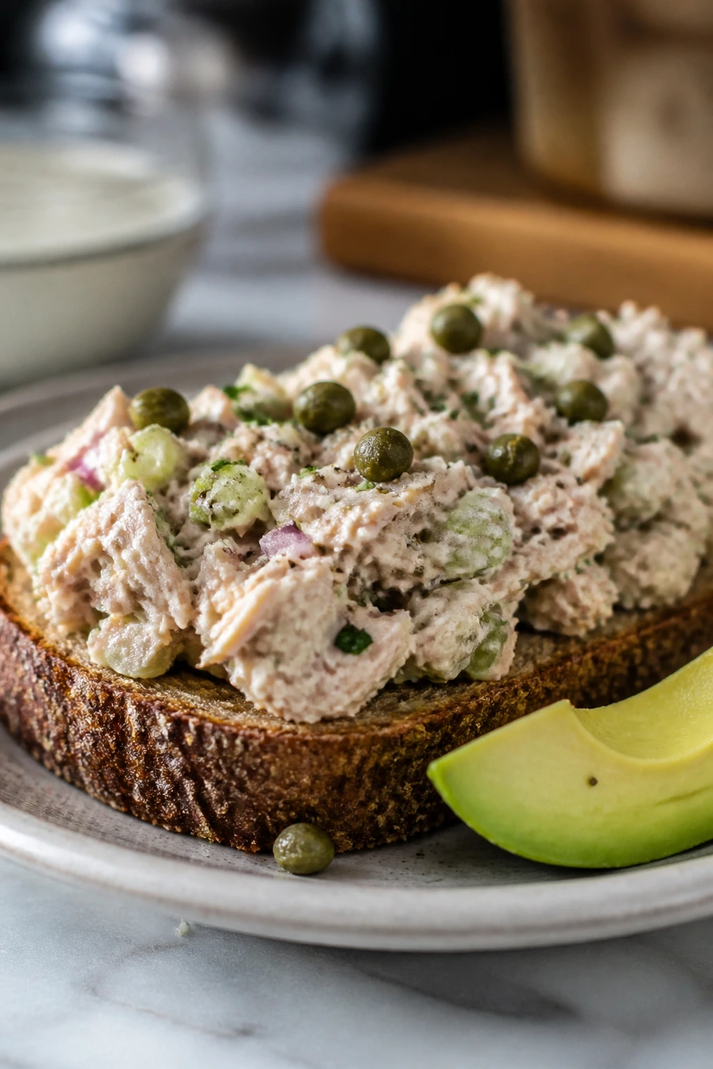 Tuna salad on rye with capers and avocado, showing variations