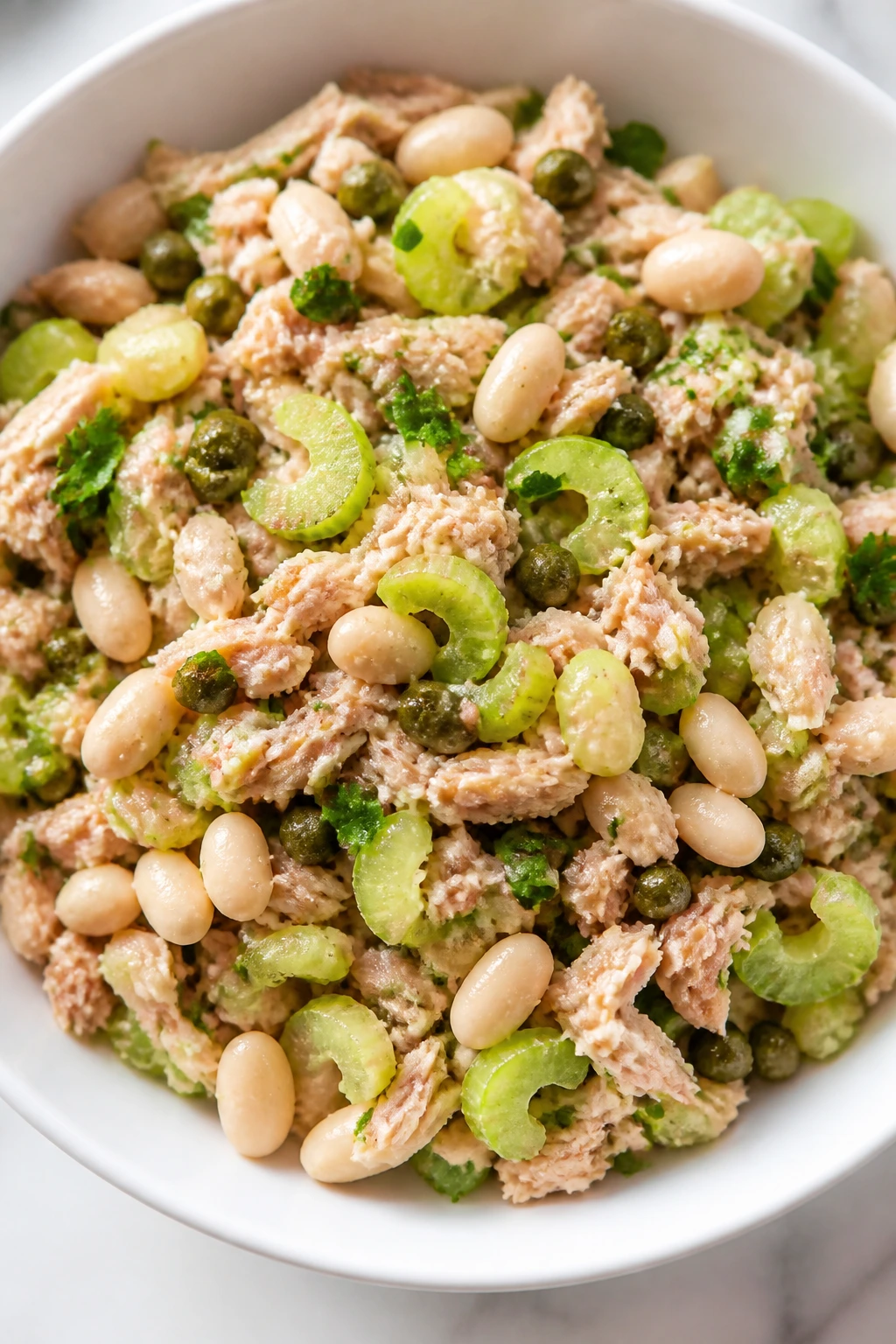 Close-up of Tuna and White Bean Salad with Celery in a bright kitchen setting.
