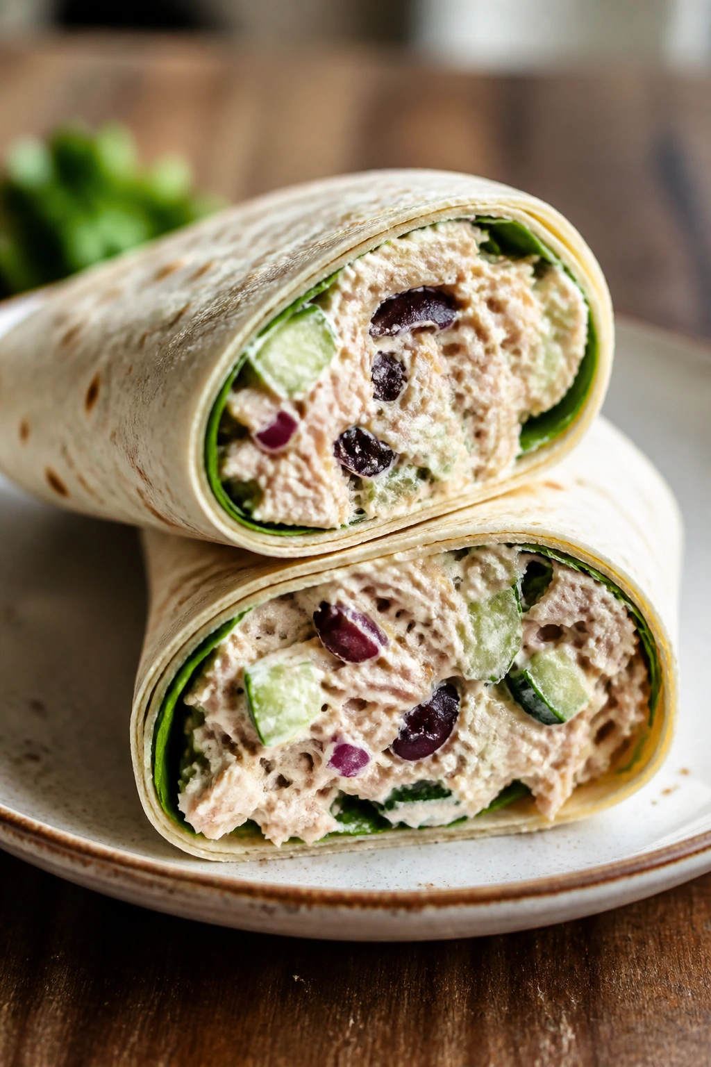 Two Mediterranean tuna salad wraps cut open to show filling