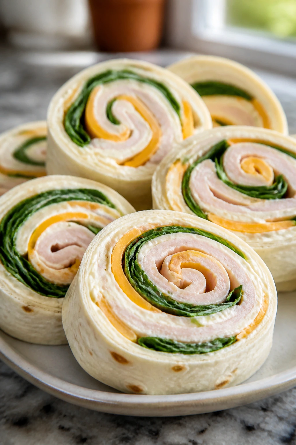 Close-up of turkey and cheddar pinwheels sliced to reveal spirals