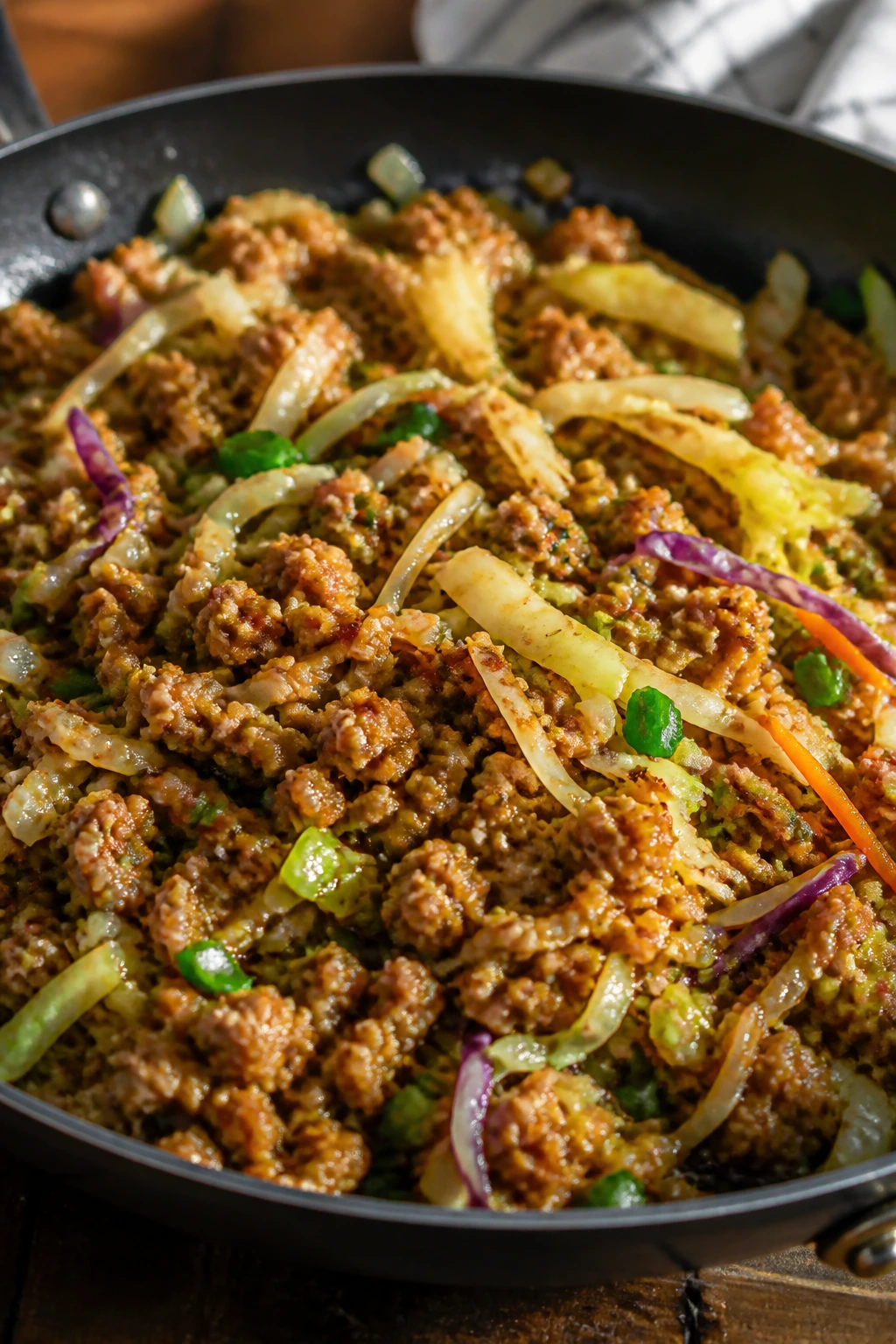 Close-up of turkey egg-roll bowl in skillet in a warm kitchen.