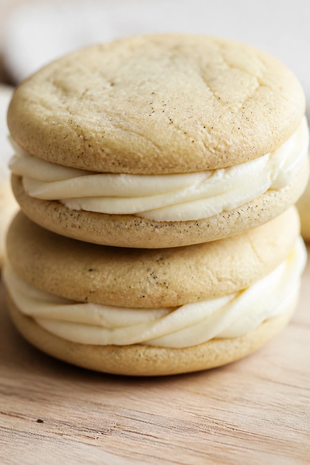 Close-up of vanilla bean sandwich cookies with buttercream filling