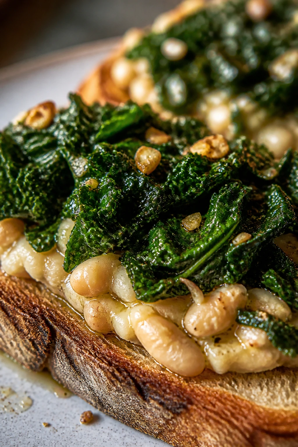 Close-up of white bean and kale toast on a rustic wooden board