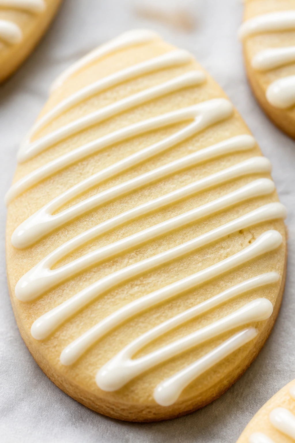 Close-up of white chocolate drizzle on Easter egg cookie