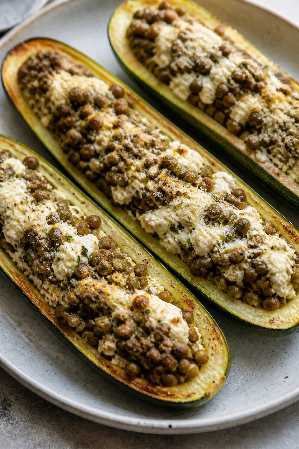 Zucchini boats filled with ricotta and lentils on a plate